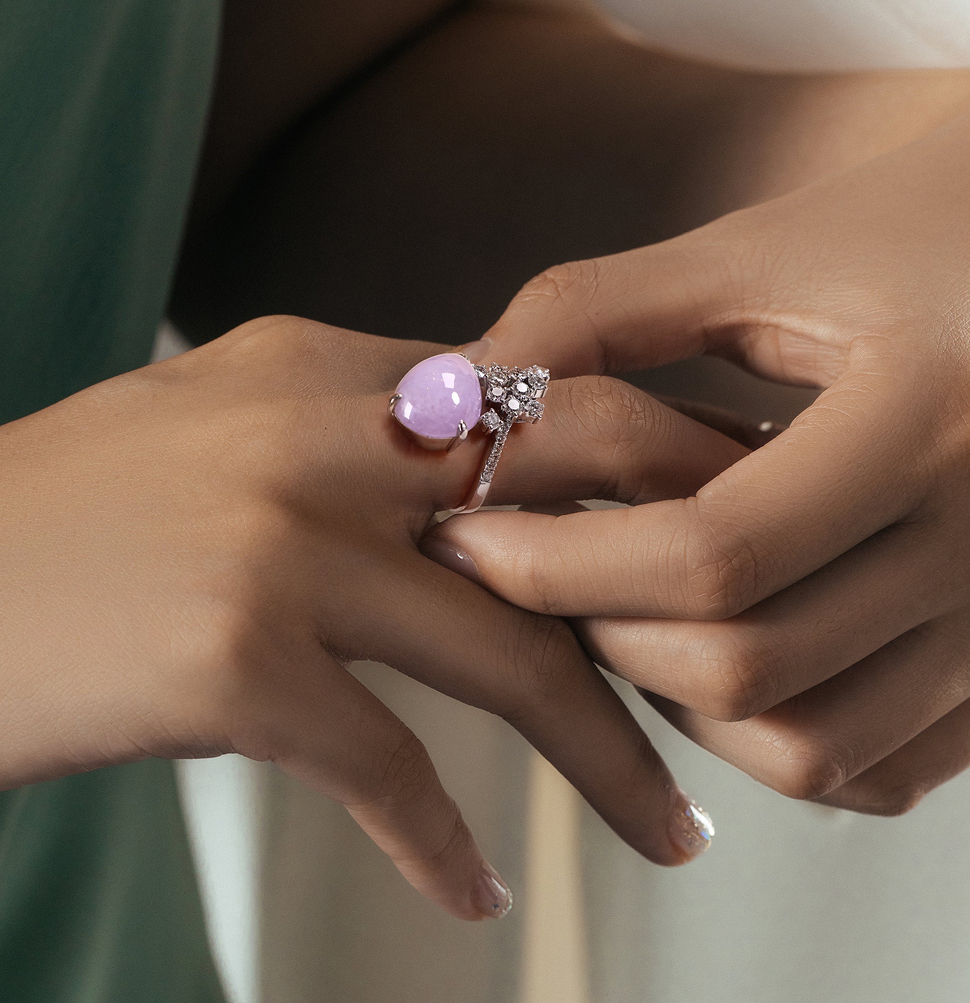 The model wore a uniquely shaped purple jade and a uniquely designed ring with multiple diamonds.