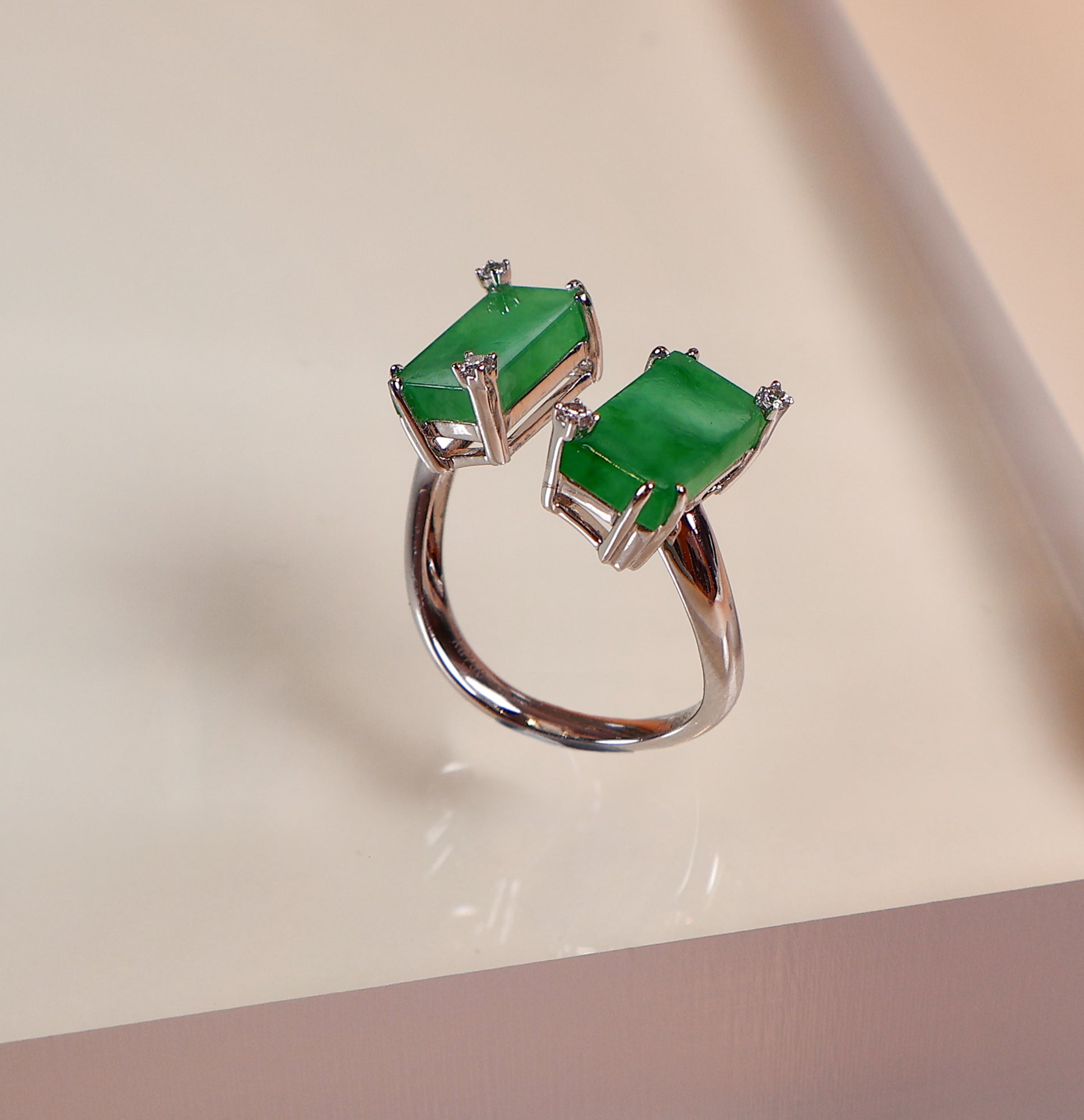 A semi-open jade ring inlaid with two jades and diamonds