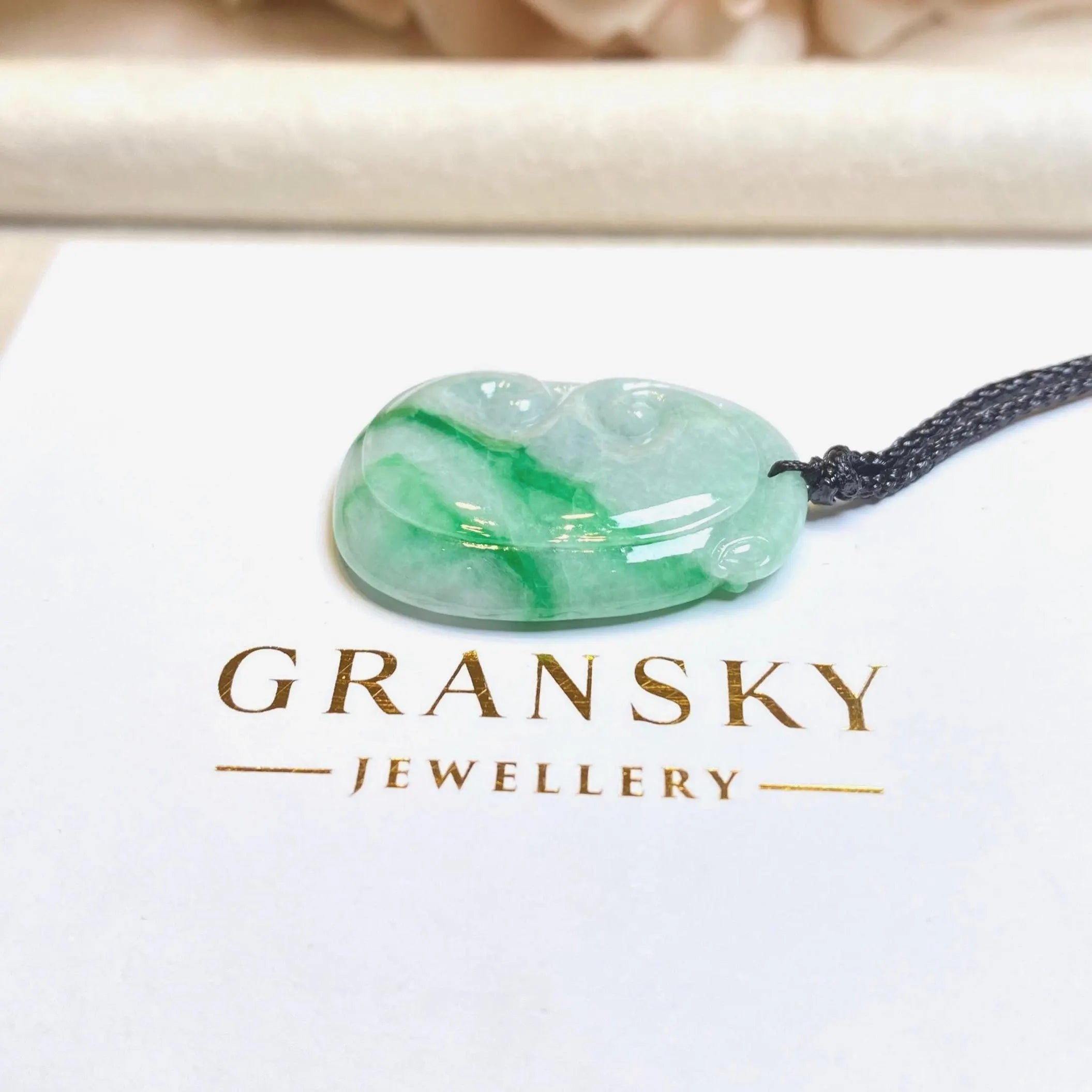 Green jade pendant on a black cord with 'Gransky Jewellery' logo below.